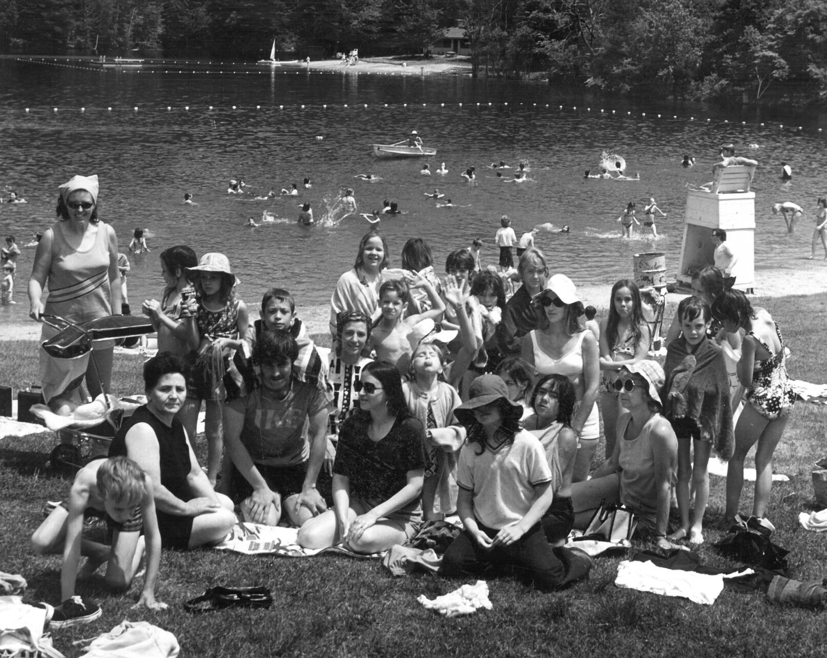 No books today! The 42 Savoy Elementary School students enjoyed a day long outing at Windsor Lake in North Adams, where they had a cookout, played games and enjoyed swimming. Principal-teacher Partricia Duffy sits in the front with dark glasses; to her right, teacher David Wright and Lucy Tilton, school committee member. June 20, 1974.